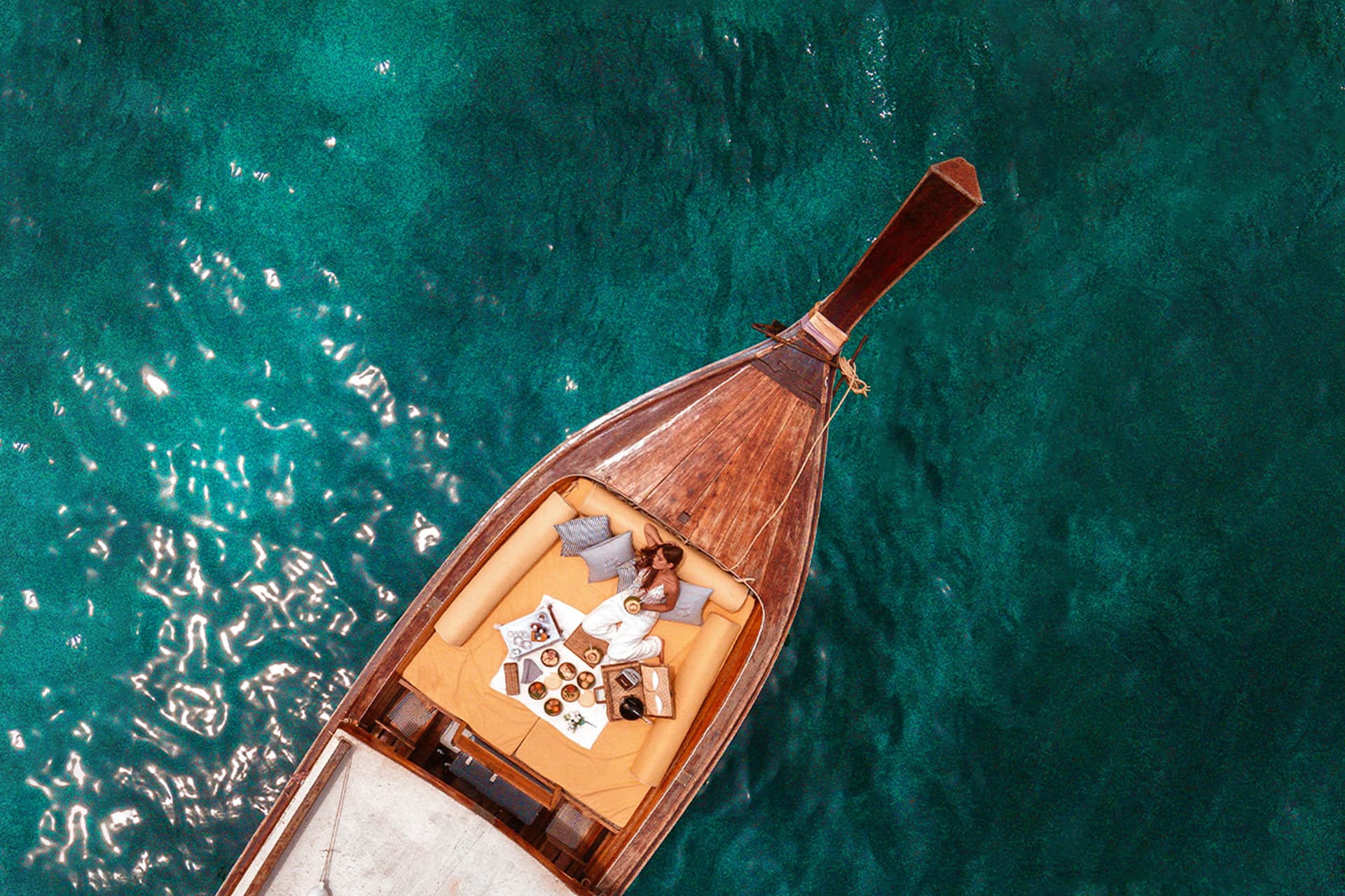 Luxury longtail boat cruising at golden hour in Thailand